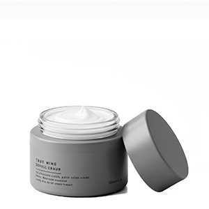 Barattolo cosmetico grigio pieno di crema